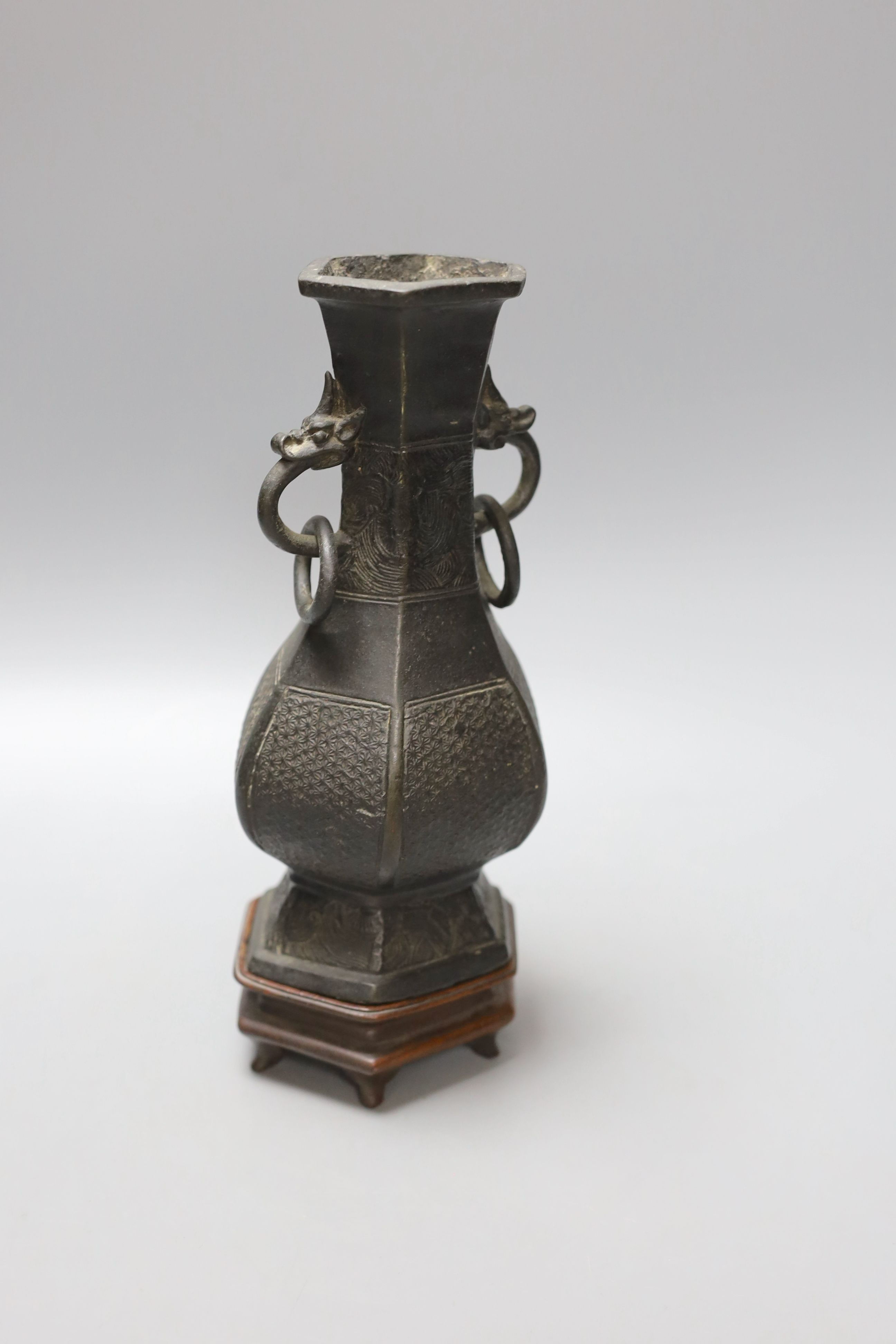 A Chinese bronze vase with ring handles, Song/Yuan Dynasty, on hardwood stand, 24cm total height